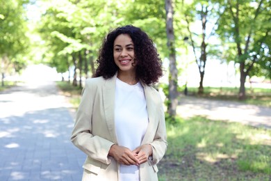 Photo of Portrait of smiling Latin American woman outdoors