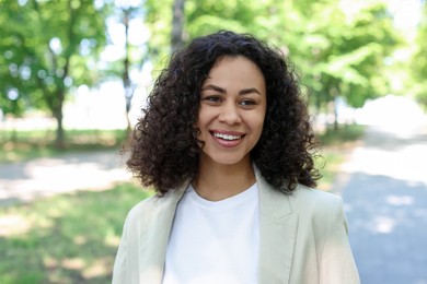 Photo of Portrait of smiling Latin American woman outdoors