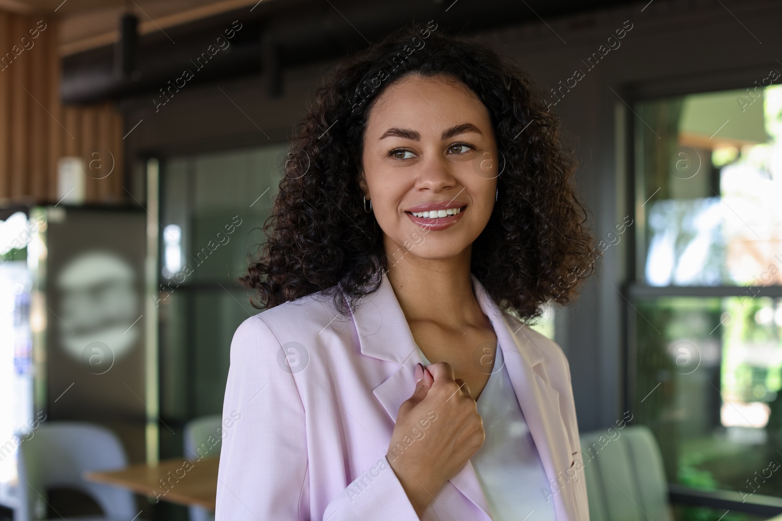 Portrait of smiling Latin American woman in cafe Photo of Portrait of smiling Latin American woman in cafe
