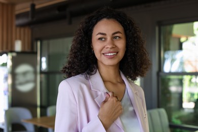 Photo of Portrait of smiling Latin American woman in cafe