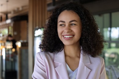 Photo of Portrait of smiling Latin American woman in cafe