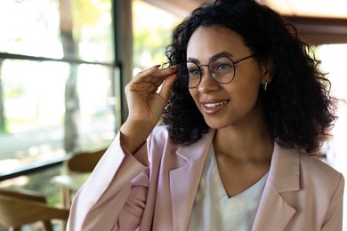 Photo of Portrait of smiling Latin American woman in cafe