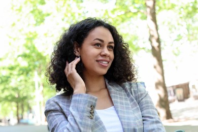 Photo of Portrait of smiling Latin American woman outdoors