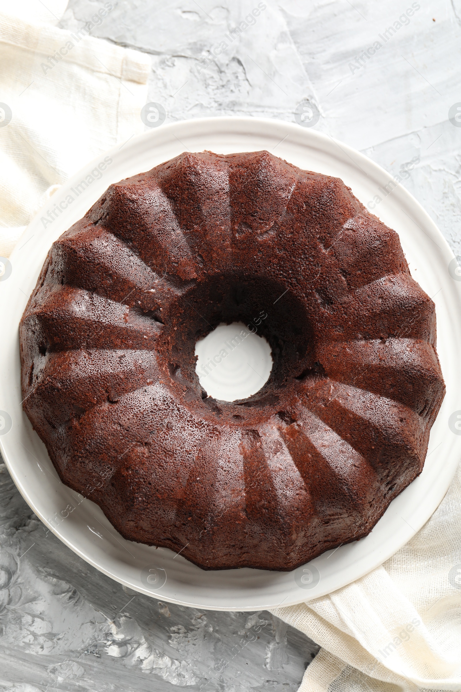 Tasty chocolate bundt cake on grey table, top view Photo of Tasty chocolate bundt cake on grey table, top view