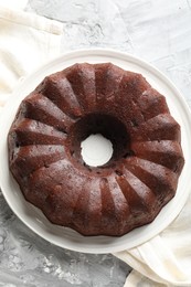 Photo of Tasty chocolate bundt cake on grey table, top view