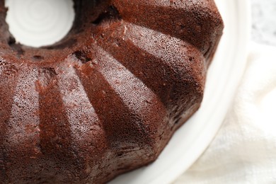 Photo of Tasty chocolate bundt cake on table, above view