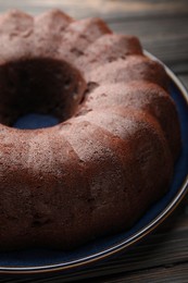 Photo of Tasty chocolate bundt cake on table, closeup