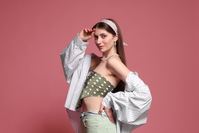 Photo of Fashionable portrait of beautiful woman in stylish outfit on pink background