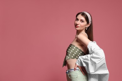 Photo of Fashionable portrait of beautiful woman in stylish outfit on pink background. Space for text