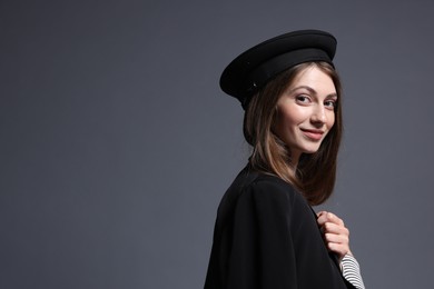 Photo of Fashionable portrait of beautiful woman in stylish outfit on grey background. Space for text