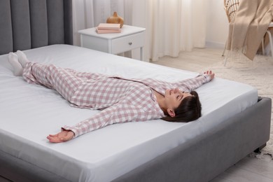 Photo of Beautiful woman lying on soft mattress at home