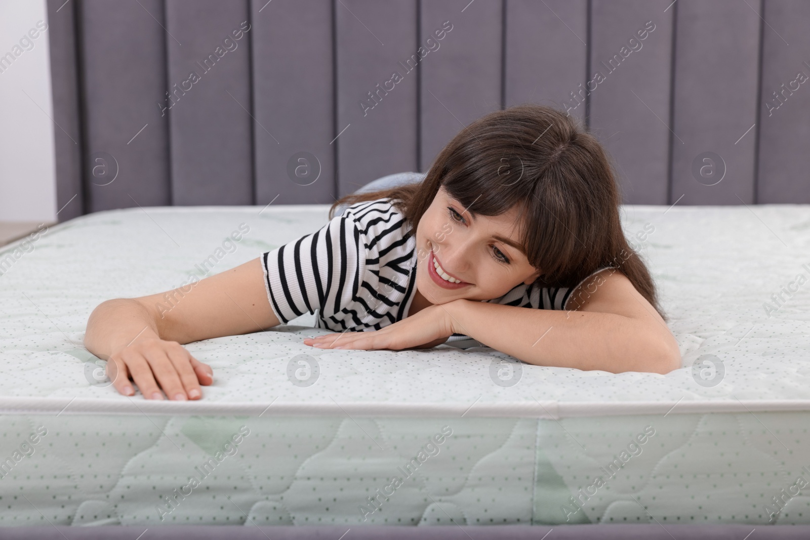 Beautiful woman lying on soft mattress at home Photo of Beautiful woman lying on soft mattress at home