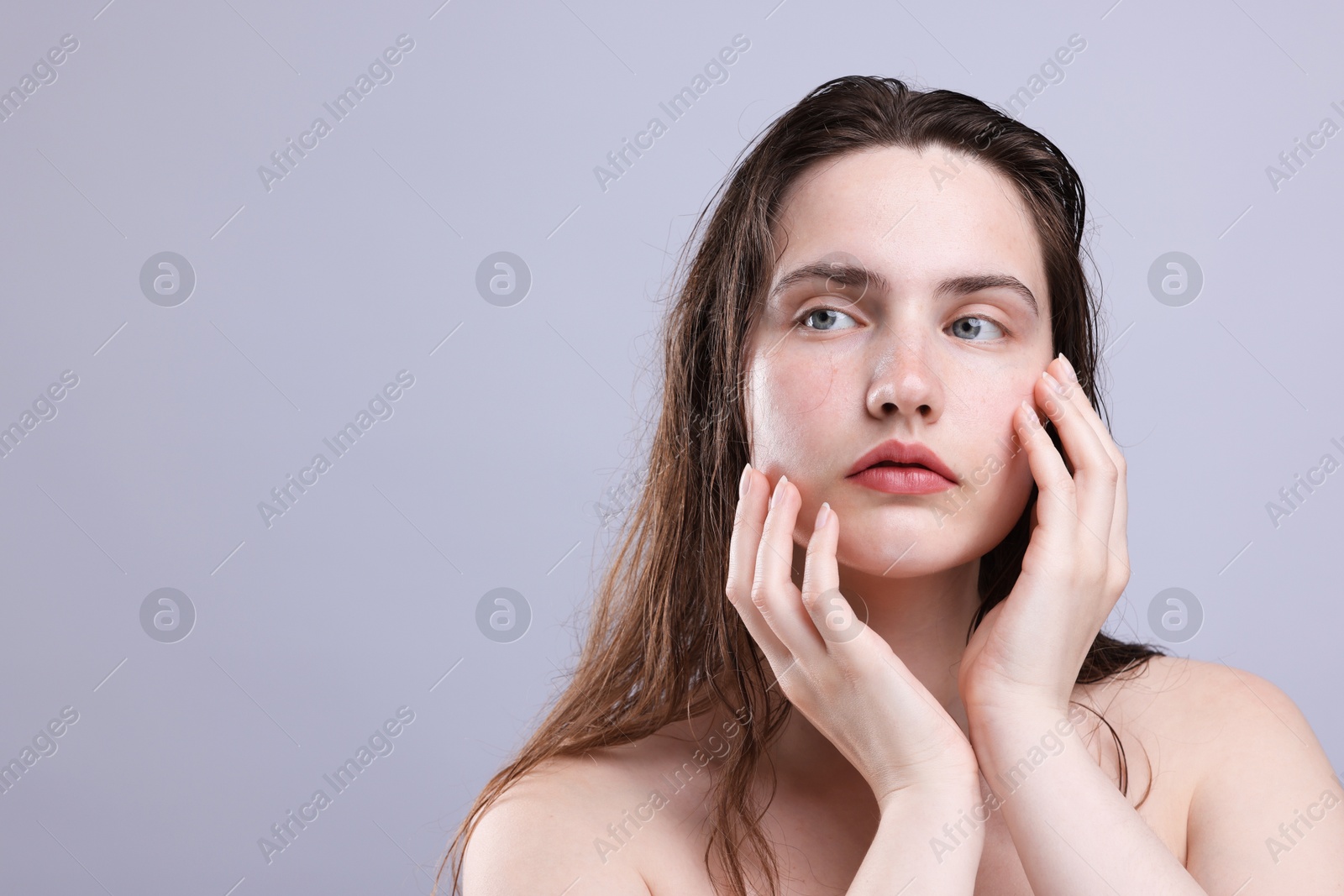 Photo of Beautiful woman with natural skin complexion on grey background, closeup. Space for text