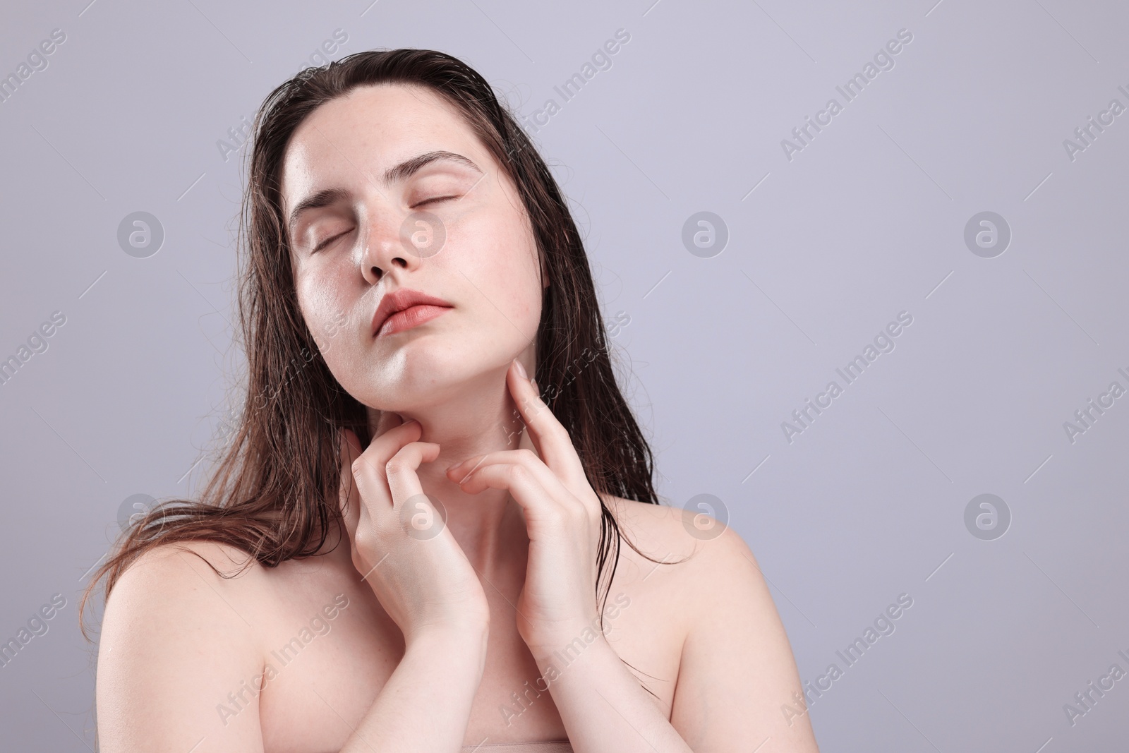 Beautiful woman with natural skin complexion on grey background, closeup. Space for text Photo of Beautiful woman with natural skin complexion on grey background, closeup. Space for text