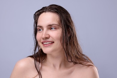 Photo of Smiling woman with natural skin complexion on grey background, closeup