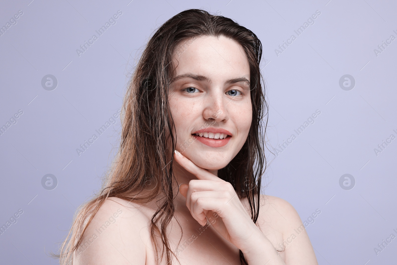 Photo of Portrait of smiling woman with natural skin complexion on grey background, closeup