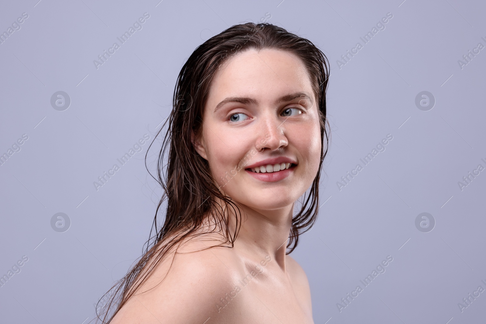 Photo of Smiling woman with natural skin complexion on grey background, closeup