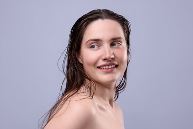 Photo of Smiling woman with natural skin complexion on grey background, closeup