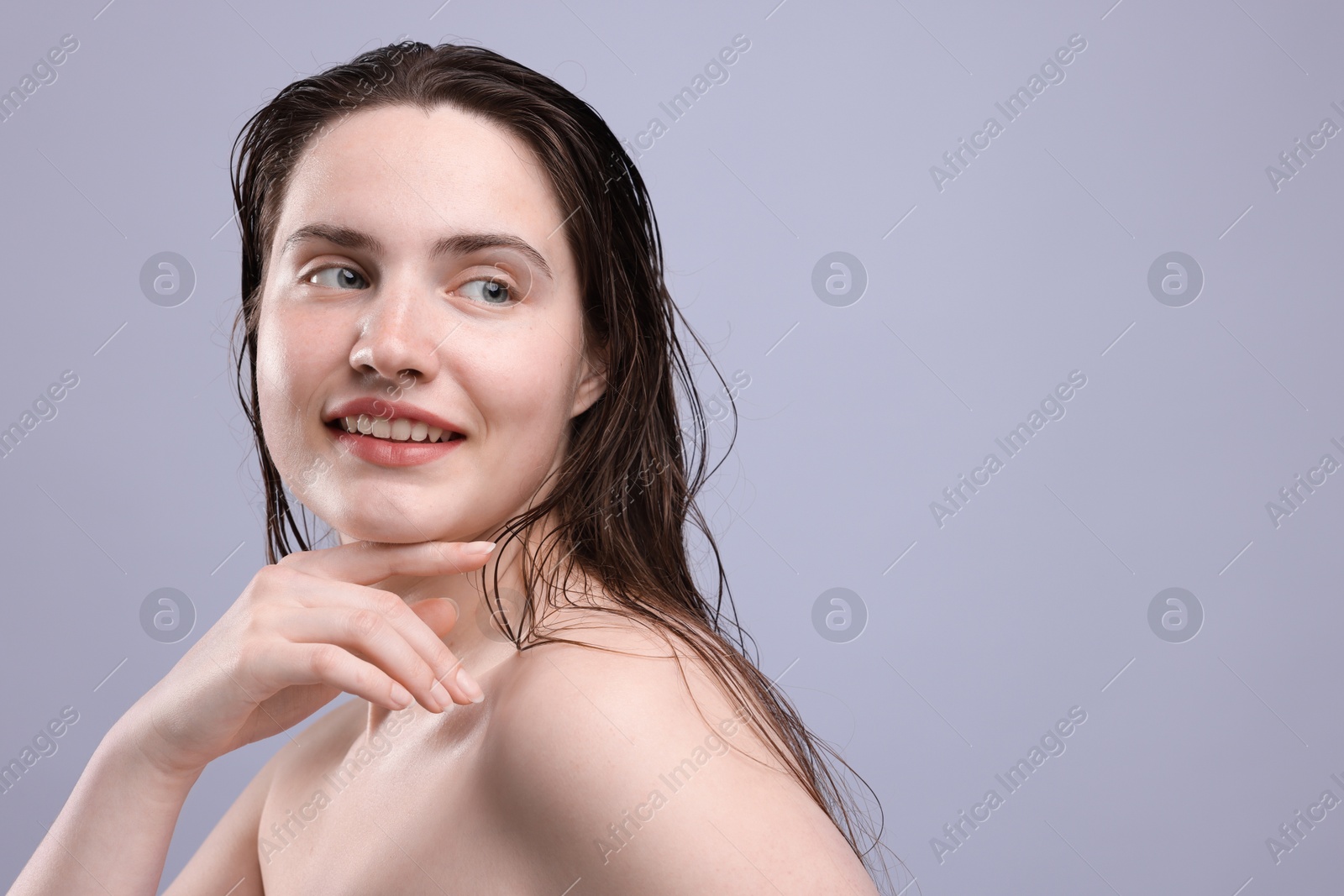 Photo of Smiling woman with natural skin complexion on grey background, closeup. Space for text