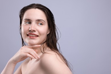 Photo of Smiling woman with natural skin complexion on grey background, closeup. Space for text