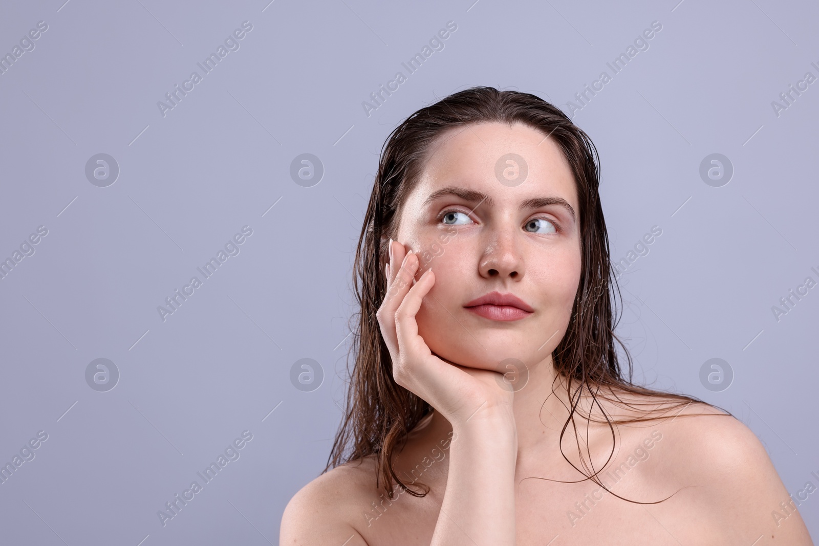 Photo of Beautiful woman with natural skin complexion on grey background, closeup. Space for text