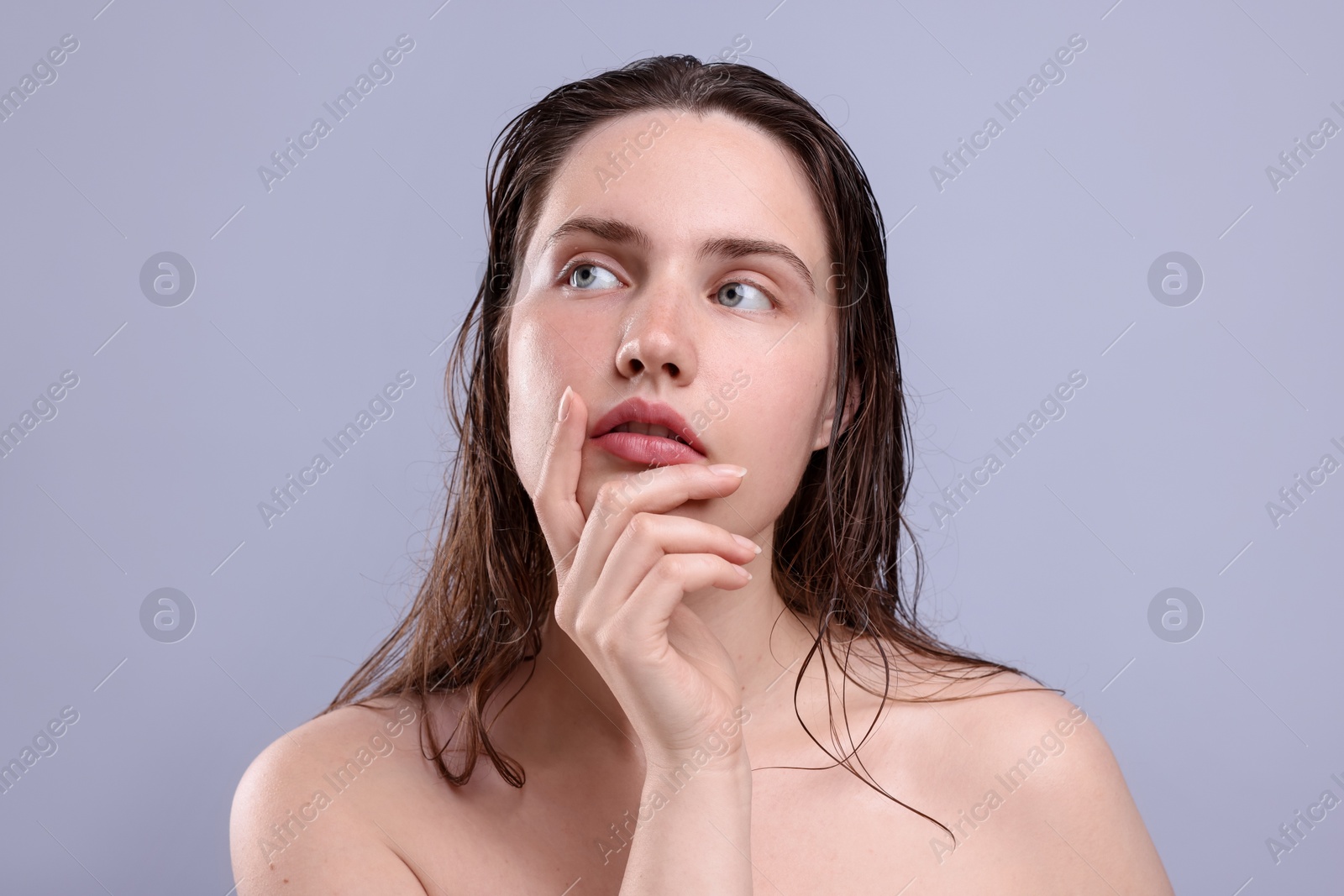 Beautiful woman with natural skin complexion on grey background, closeup Photo of Beautiful woman with natural skin complexion on grey background, closeup
