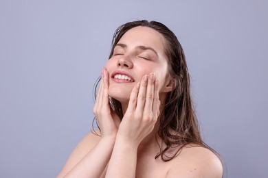 Photo of Smiling woman with natural skin complexion on grey background, closeup