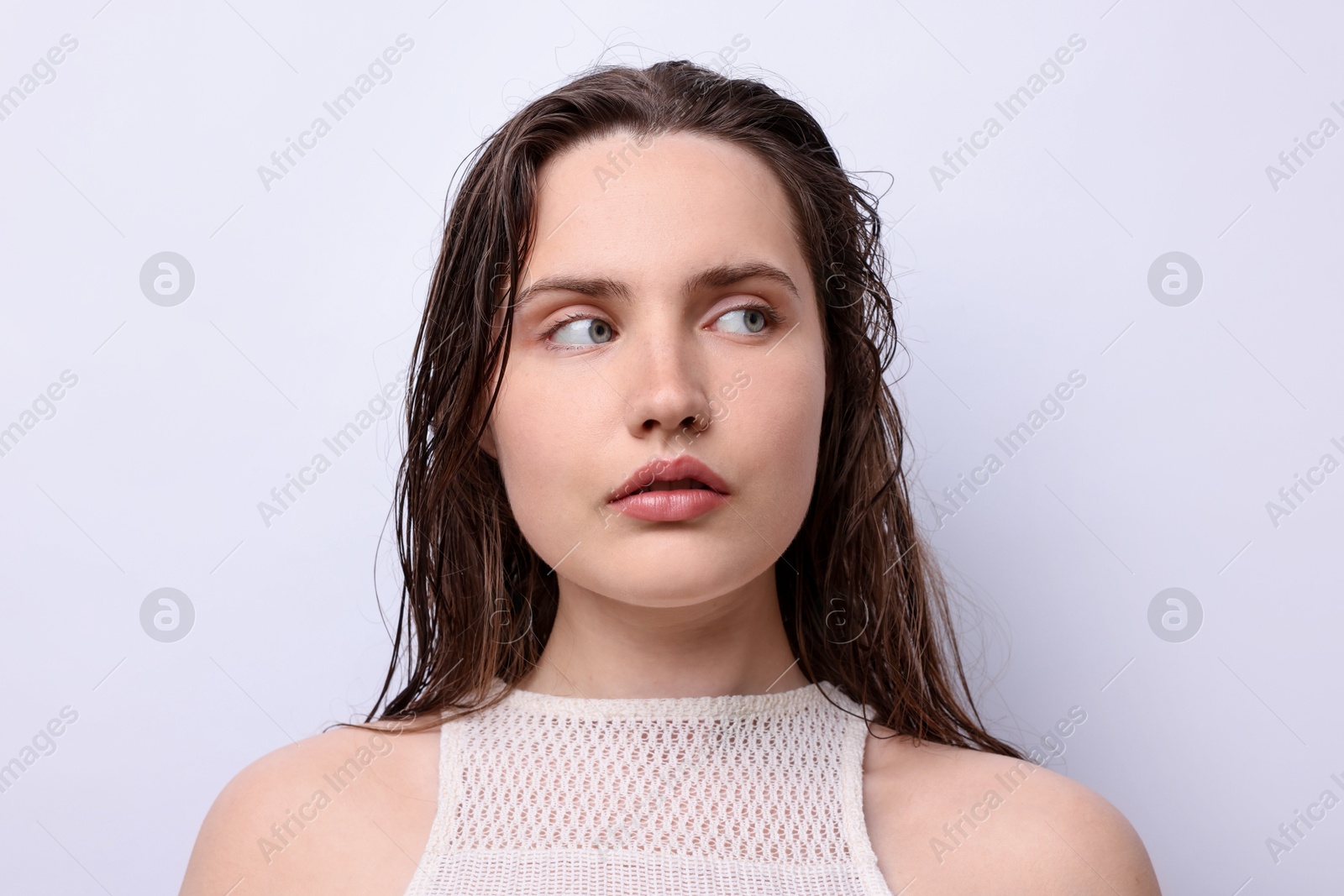 Photo of Portrait of beautiful woman with natural skin complexion on light grey background, closeup