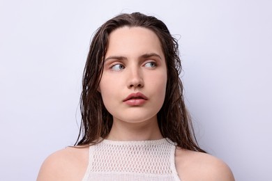 Photo of Portrait of beautiful woman with natural skin complexion on light grey background, closeup