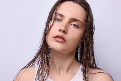 Photo of Portrait of beautiful woman with natural skin complexion on light grey background, closeup