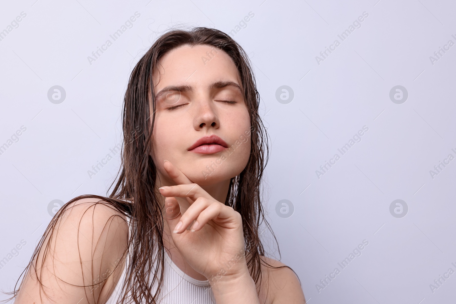 Photo of Beautiful woman with natural skin complexion on light grey background, closeup. Space for text