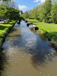 Photo of Canal with moored boats outdoors on sunny day