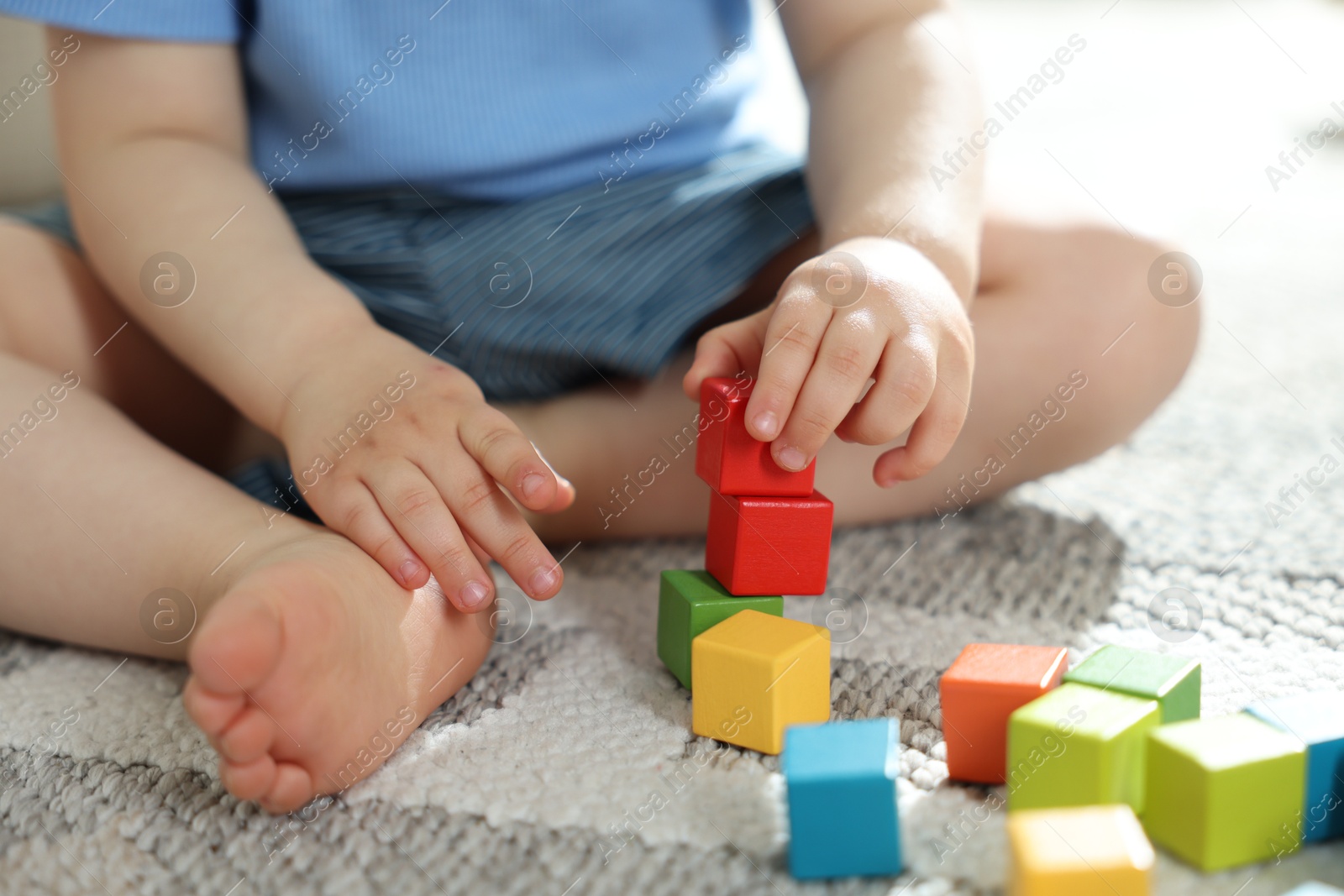 Cute little child playing with colorful cubes at home, closeup Photo of Cute little child playing with colorful cubes at home, closeup