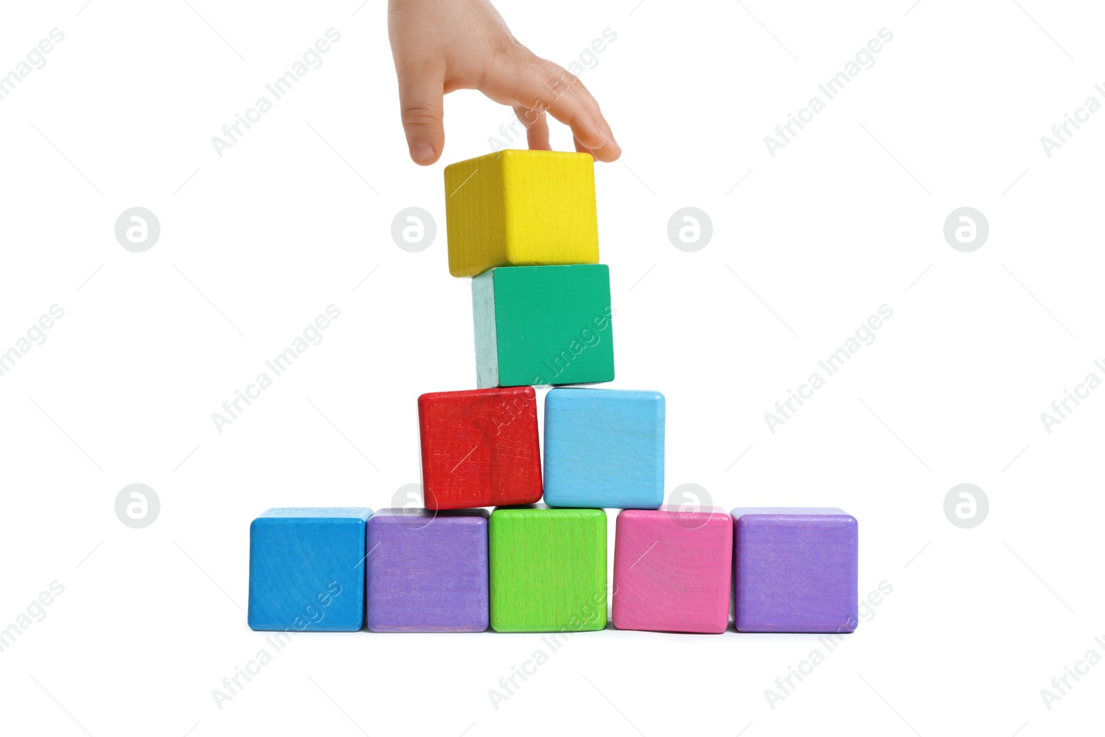 Child playing with colorful cubes on white background, closeup Photo of Child playing with colorful cubes on white background, closeup