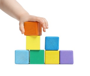 Photo of Child playing with colorful cubes on white background, closeup