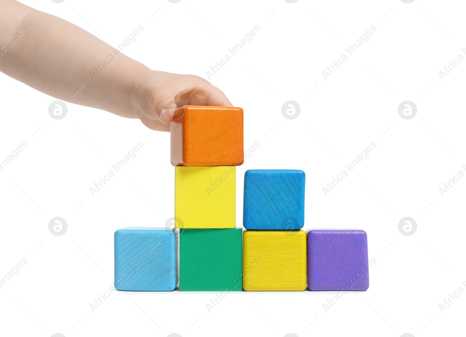 Child playing with colorful cubes on white background, closeup Photo of Child playing with colorful cubes on white background, closeup