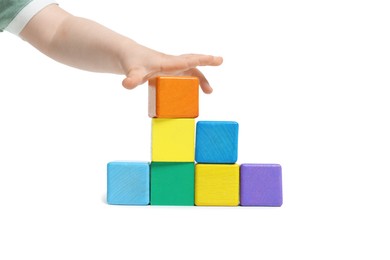Photo of Child playing with colorful cubes on white background, closeup