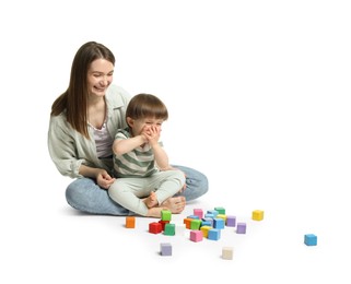 Photo of Mother and son playing with colorful cubes on white background