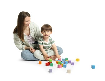 Photo of Mother and son playing with colorful cubes on white background