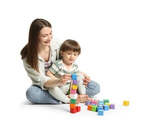 Photo of Mother and son playing with colorful cubes on white background