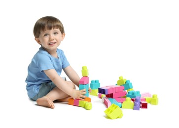 Photo of Cute little boy playing with building bricks on white background