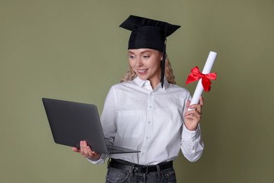 Photo of Happy student with diploma and laptop after graduation on green background