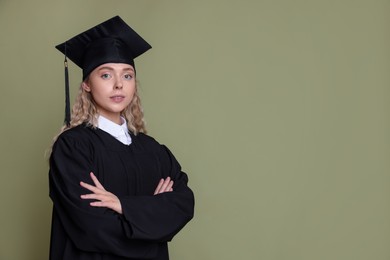 Photo of Student with crossed arms after graduation on green background. Space for text