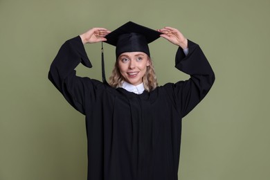Photo of Happy student after graduation on green background