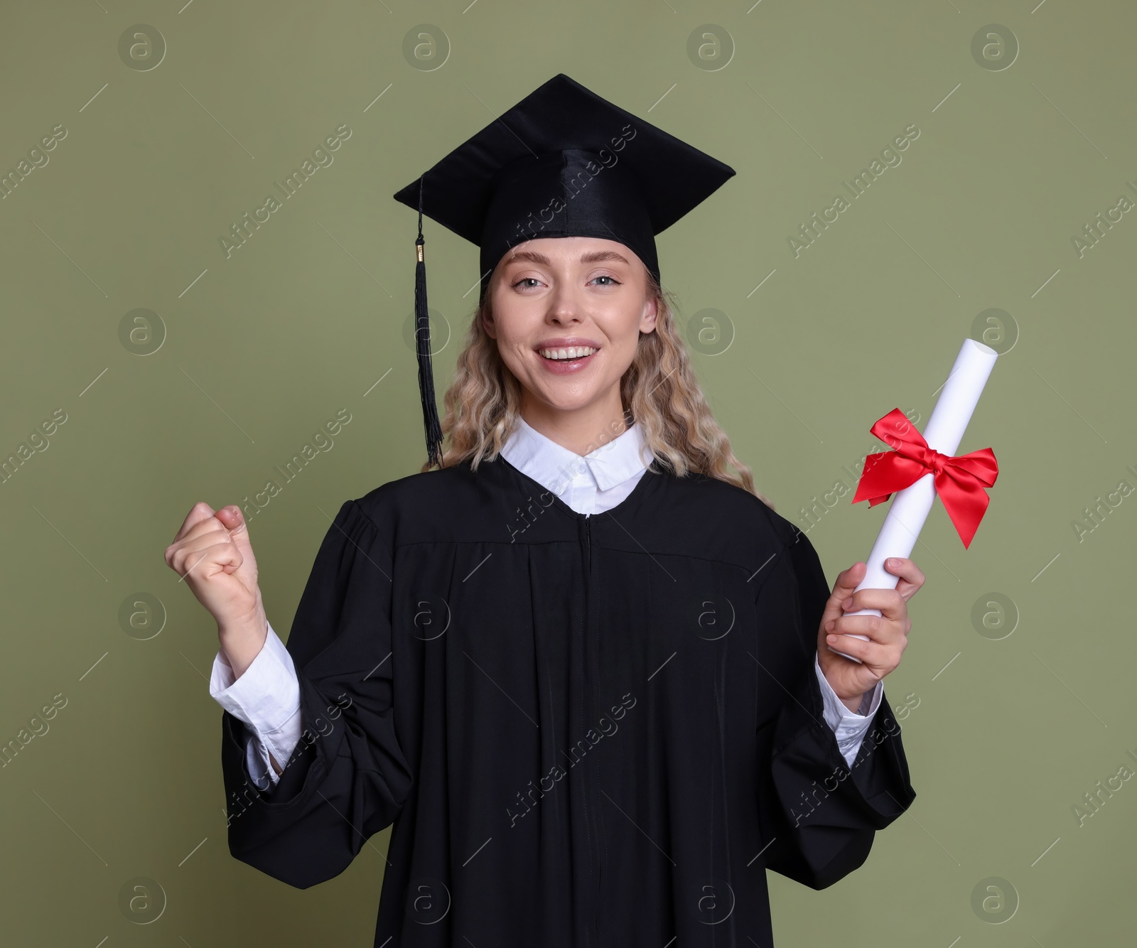 Photo of Happy student with diploma after graduation on green background
