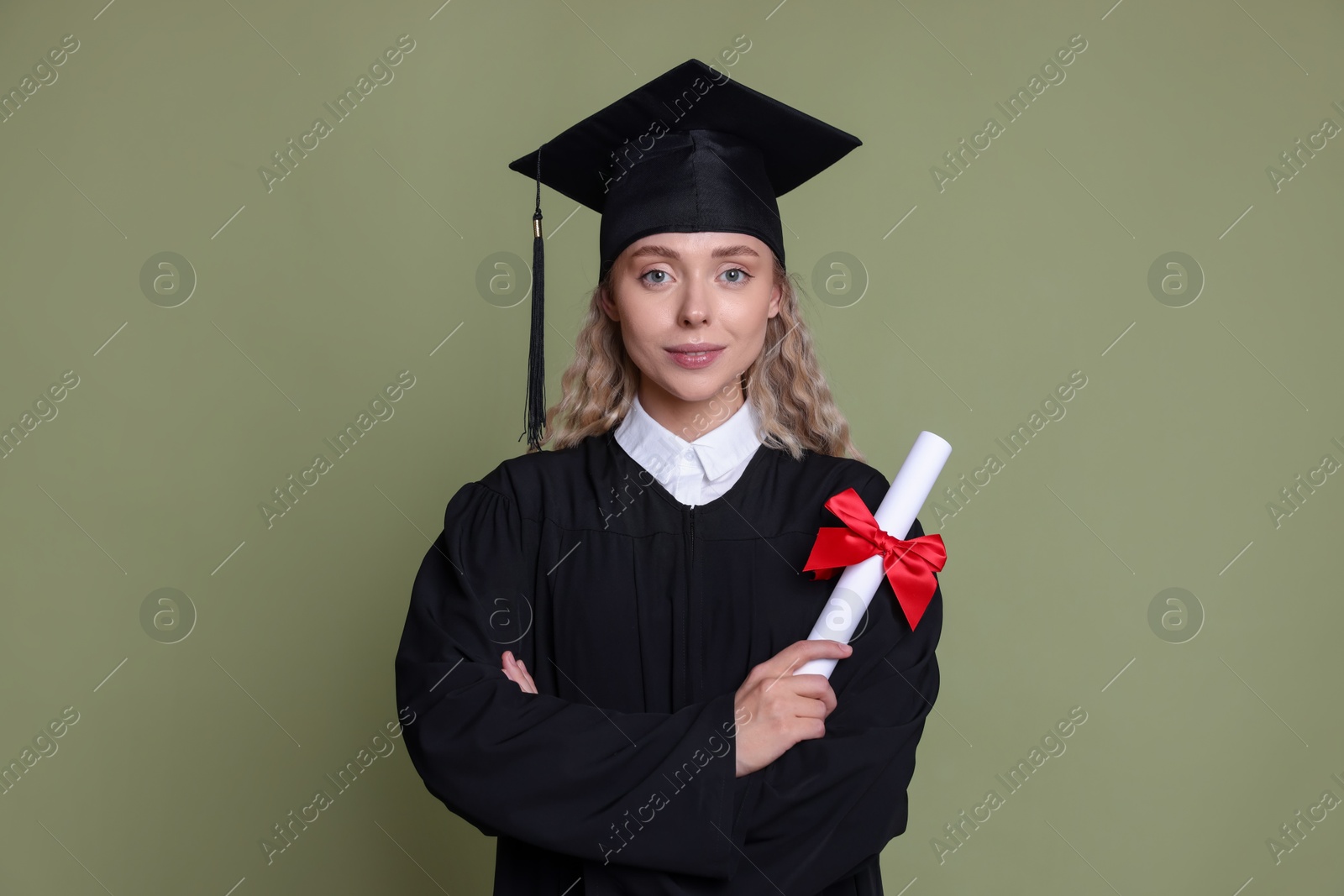 Photo of Happy student with diploma after graduation on green background