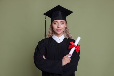 Photo of Happy student with diploma after graduation on green background