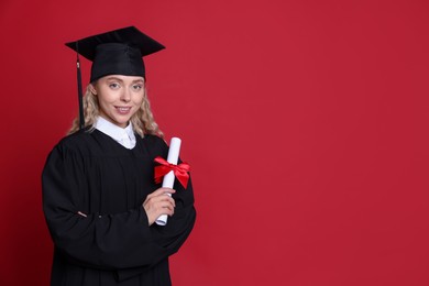 Photo of Happy student with diploma after graduation on red background. Space for text