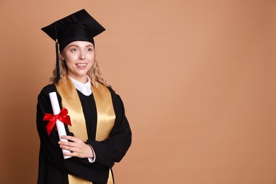 Photo of Happy student with diploma after graduation on beige background. Space for text