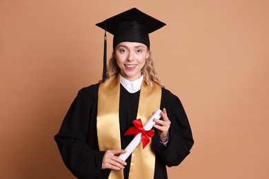 Photo of Happy student with diploma after graduation on beige background